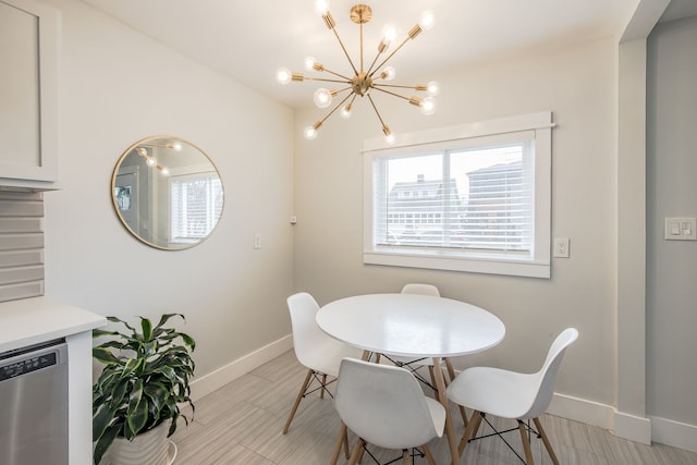 dining room featuring an inviting chandelier, baseboards, and light wood finished floors