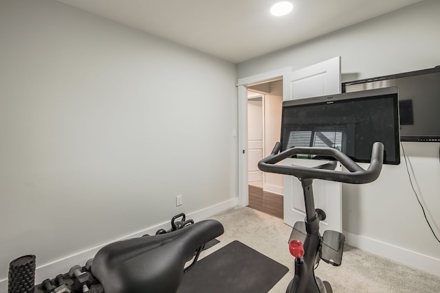 exercise room featuring carpet floors and baseboards