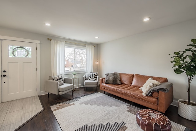 living room with baseboards, wood finished floors, and recessed lighting