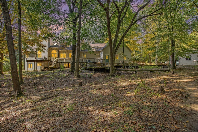 view of yard with a deck and stairs