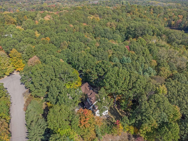 birds eye view of property with a view of trees