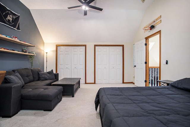 bedroom featuring carpet, multiple closets, a ceiling fan, vaulted ceiling, and a textured ceiling