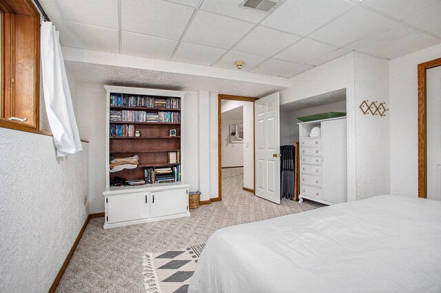 bedroom featuring carpet, visible vents, and a paneled ceiling