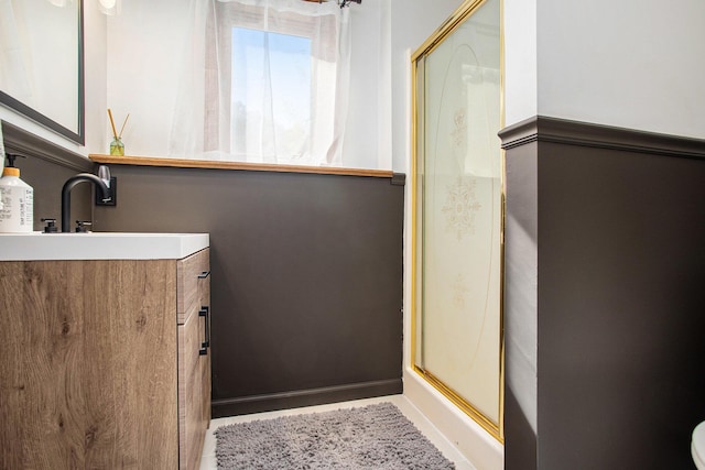 full bath with a shower stall, baseboards, and vanity