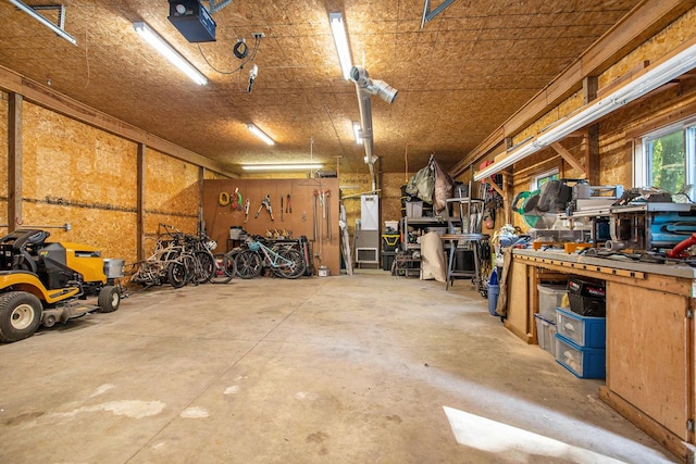 garage featuring a workshop area and a garage door opener