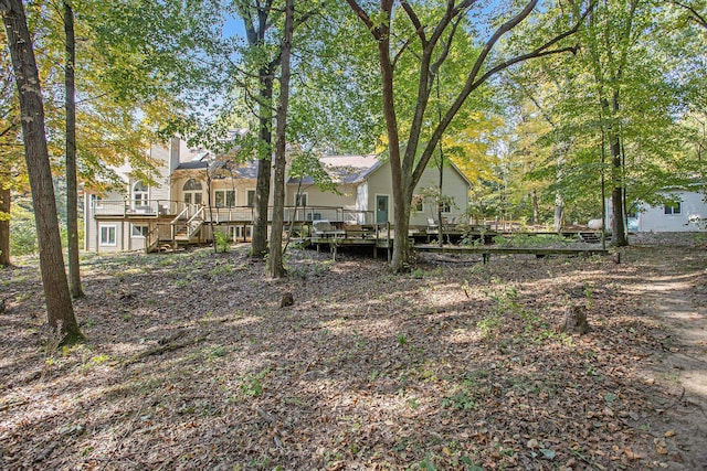 view of yard with stairs and a deck