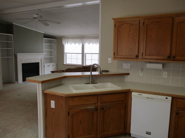 kitchen with light carpet, dishwasher, open floor plan, a peninsula, and a sink