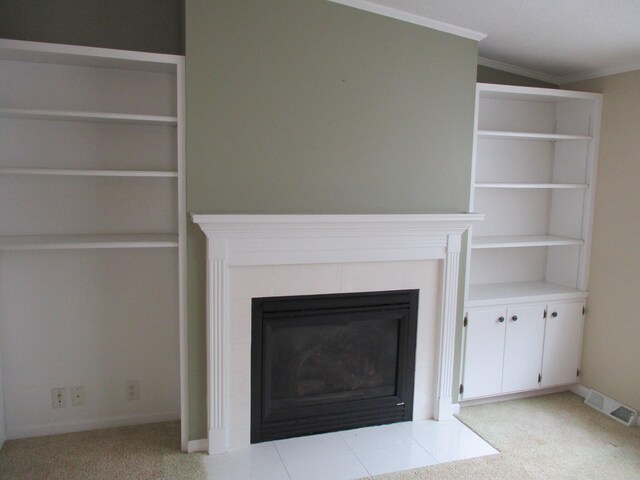 unfurnished living room featuring baseboards, visible vents, crown molding, carpet floors, and a fireplace