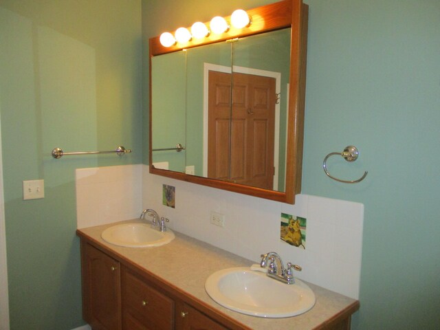 full bathroom featuring a sink, decorative backsplash, and double vanity