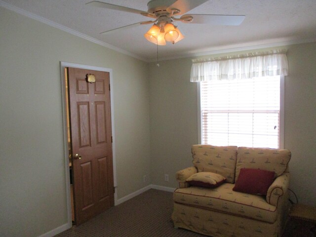 living area with carpet floors, ceiling fan, baseboards, and crown molding