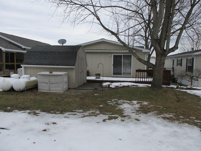 exterior space featuring roof with shingles, an outdoor structure, and a shed