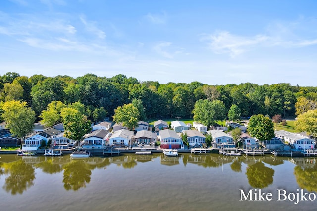 drone / aerial view featuring a water view and a residential view