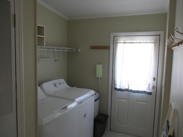 laundry area with ornamental molding, washing machine and dryer, and laundry area