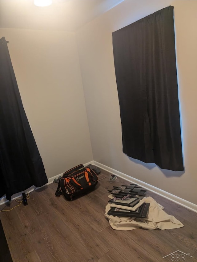 empty room with wood finished floors and baseboards