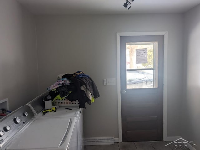 laundry room featuring laundry area, washing machine and dryer, baseboards, and tile patterned floors