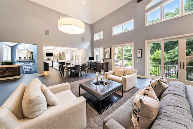 living area with french doors, visible vents, and baseboards