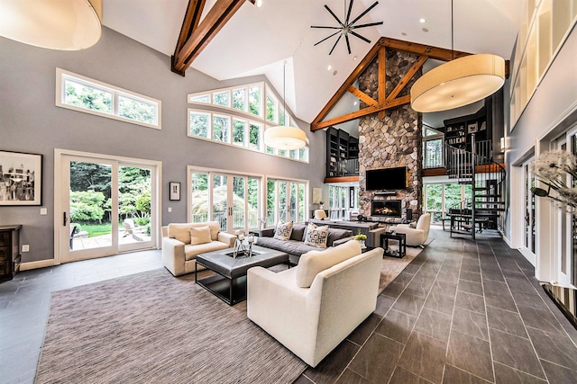 living room featuring baseboards, beamed ceiling, stairs, a fireplace, and high vaulted ceiling