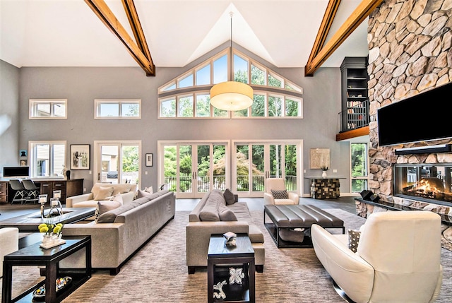 living area featuring high vaulted ceiling, a stone fireplace, and beam ceiling