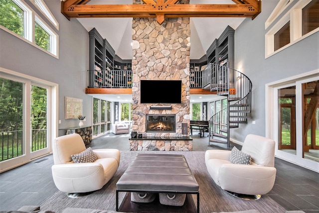 living room featuring visible vents, a fireplace, beamed ceiling, and stairs