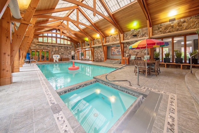 view of swimming pool with a patio area, a pool with connected hot tub, and a fireplace