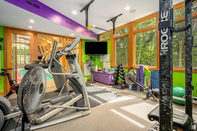 exercise room featuring rail lighting, visible vents, and recessed lighting