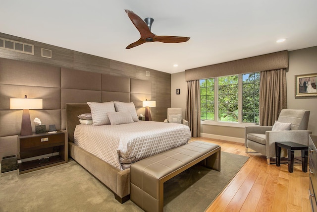 bedroom with light wood finished floors, visible vents, baseboards, and recessed lighting