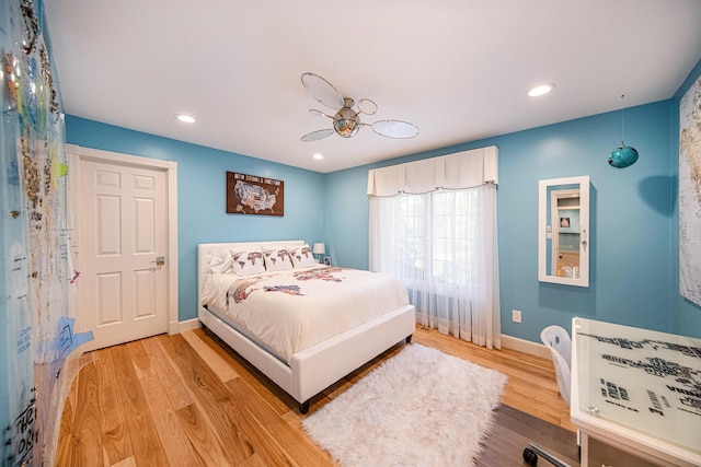 bedroom with baseboards, recessed lighting, and light wood-style floors