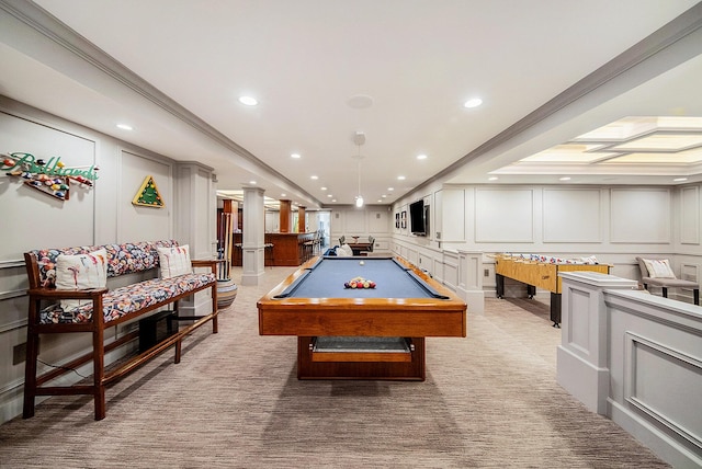 game room with pool table, a decorative wall, crown molding, and light colored carpet