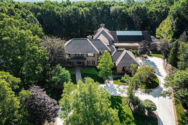 drone / aerial view featuring a wooded view