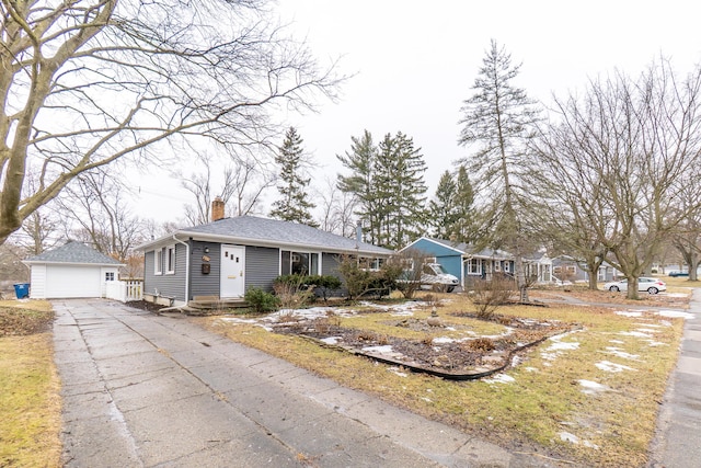 single story home featuring a garage, roof with shingles, a chimney, and an outdoor structure