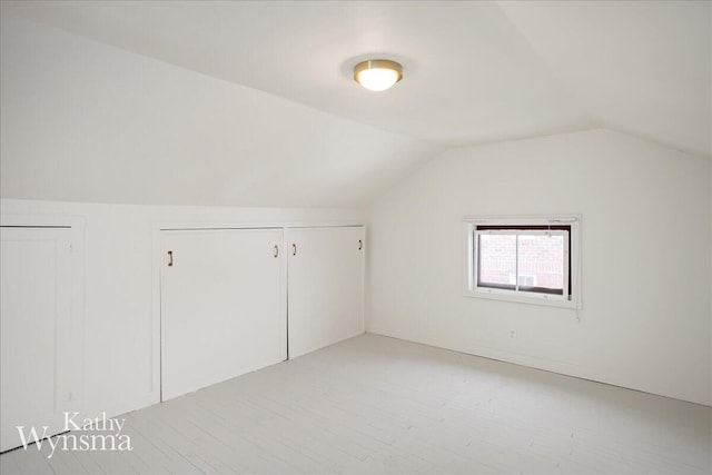 additional living space featuring lofted ceiling and light wood finished floors