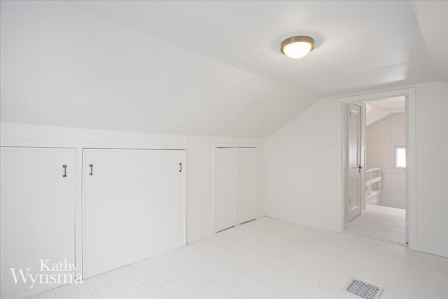 bonus room with lofted ceiling and visible vents