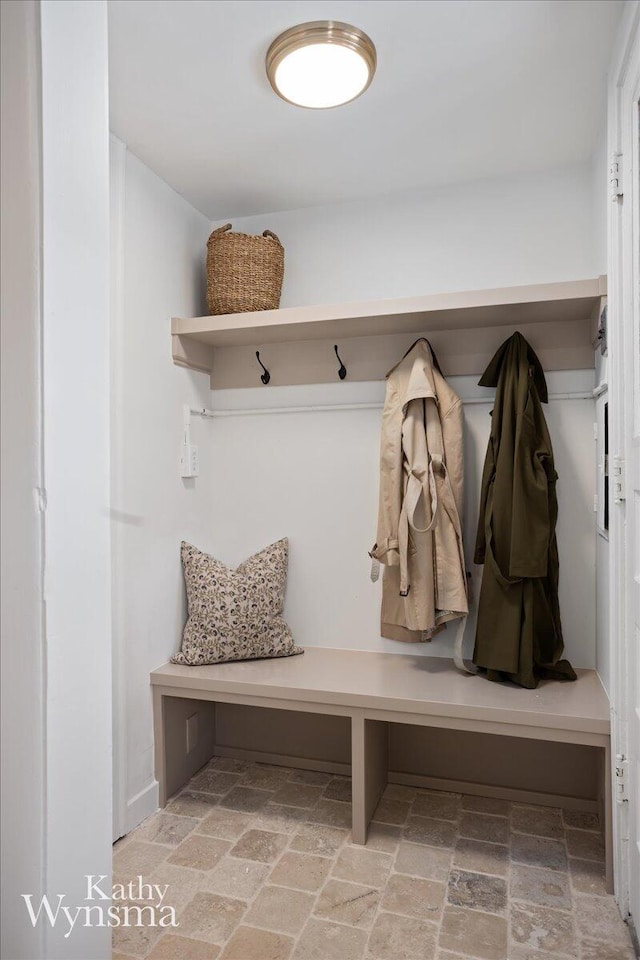 mudroom featuring stone finish floor