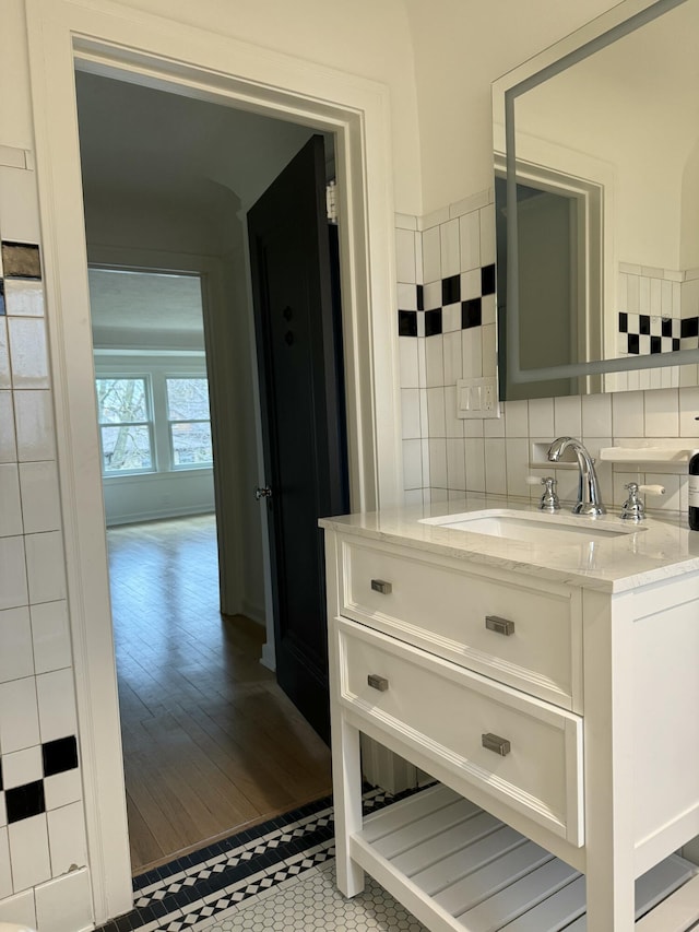 bathroom featuring tile patterned floors, tasteful backsplash, and vanity