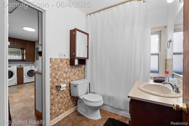 27320 Ryan Rd, Warren, MI 48092 - bathroom with washer and dryer, vanity, toilet, and shower / bath combination with curtain