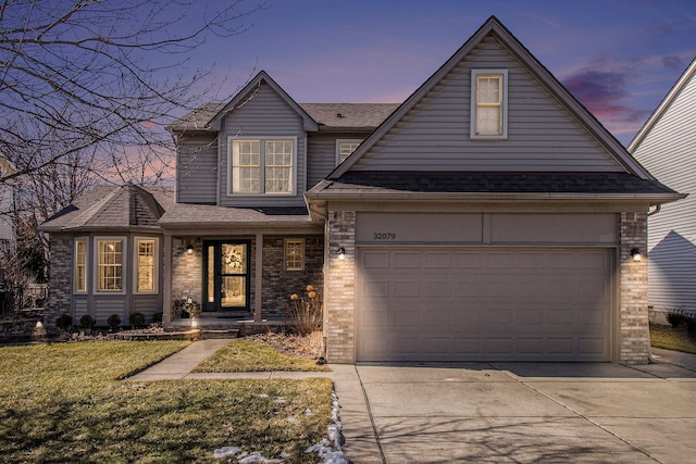 traditional-style house featuring driveway, a yard, and brick siding