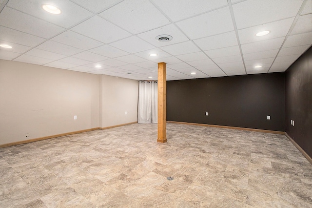 finished below grade area featuring recessed lighting, a paneled ceiling, and baseboards