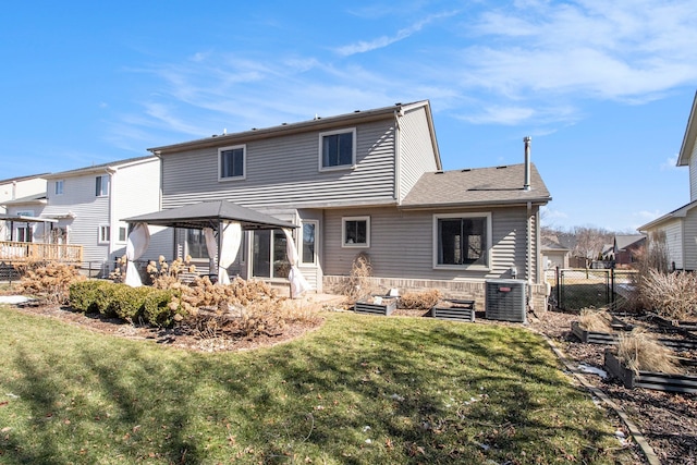 back of property featuring a lawn, fence, a gazebo, and central AC unit