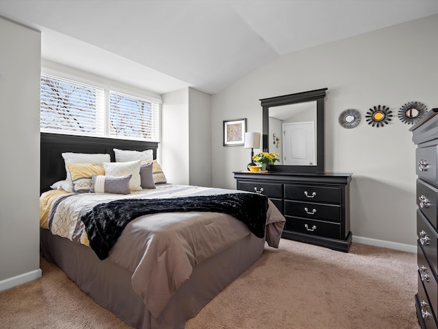 bedroom with carpet, lofted ceiling, and baseboards