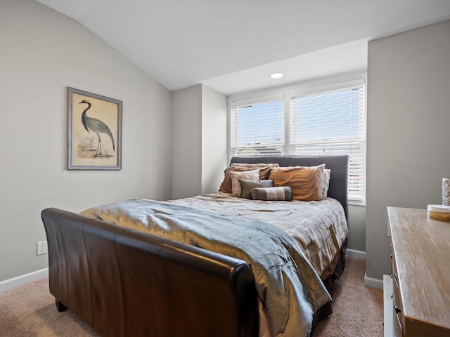 bedroom with carpet floors, baseboards, and vaulted ceiling