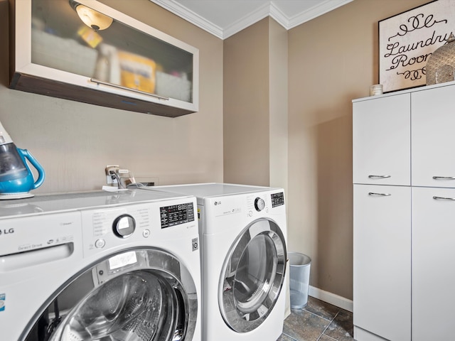 clothes washing area featuring baseboards, washer and dryer, ornamental molding, cabinet space, and stone finish flooring