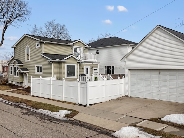 view of front of property featuring a fenced front yard, driveway, and a balcony