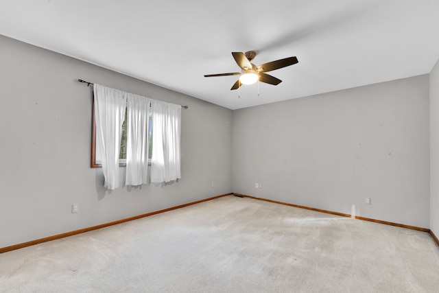 unfurnished room featuring carpet floors, baseboards, and a ceiling fan