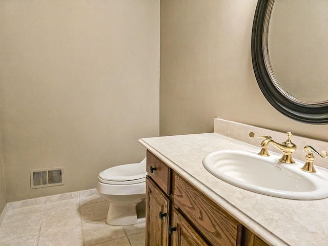 half bath featuring baseboards, visible vents, toilet, tile patterned floors, and vanity