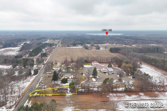 snowy aerial view featuring a rural view