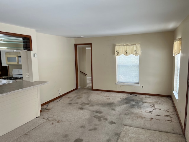 carpeted spare room with baseboards and visible vents