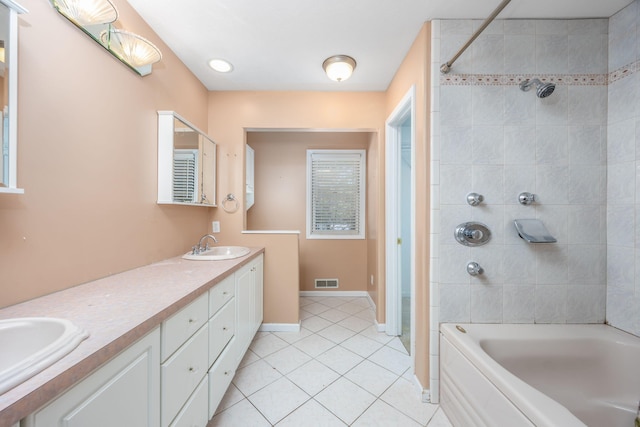 full bath with double vanity, visible vents, tile patterned flooring, bathtub / shower combination, and a sink