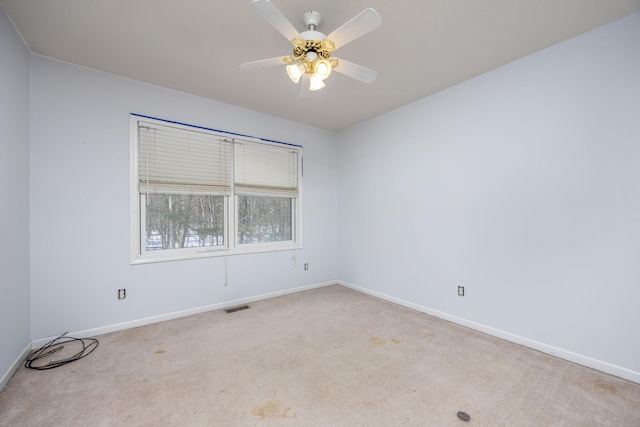 unfurnished room featuring carpet floors, ceiling fan, and baseboards