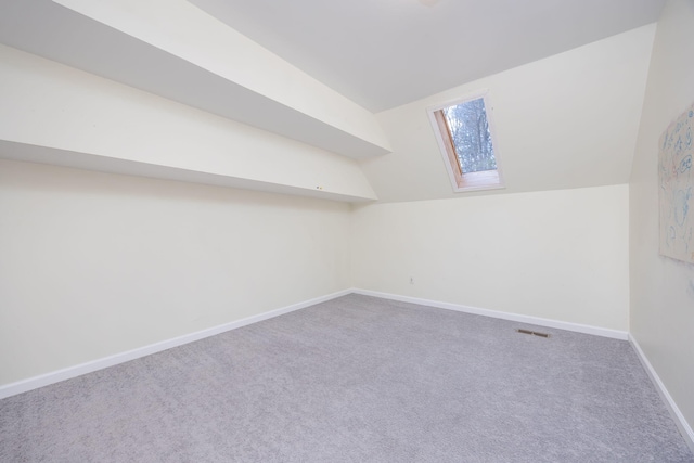 additional living space with lofted ceiling, carpet flooring, and baseboards