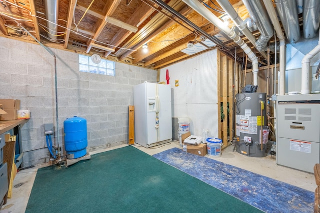 below grade area featuring water heater and white fridge with ice dispenser